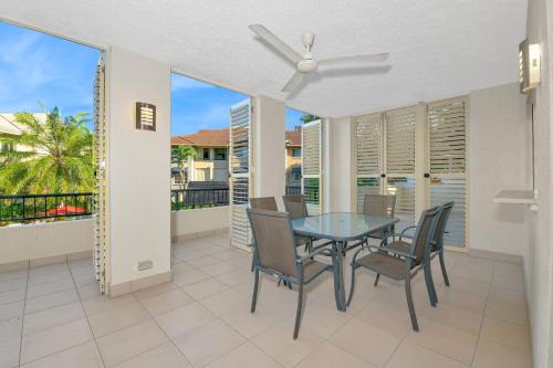 a dining room with a table and chairs on a balcony at The Lakes Resort Cairns in Cairns