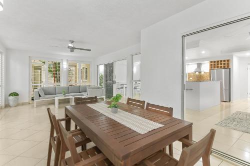 a dining room with a wooden table and chairs at The Lakes Resort Cairns in Cairns