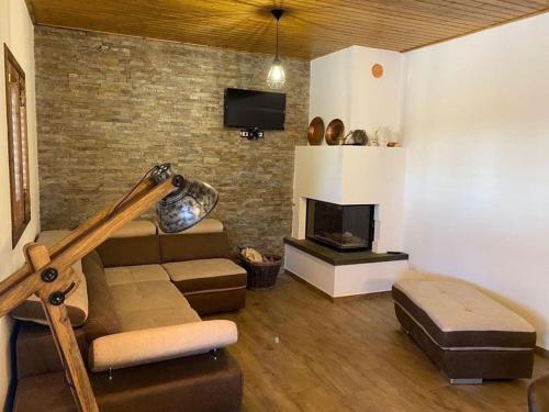 a living room with a couch and a fireplace at Chalet in campagna in Partanna