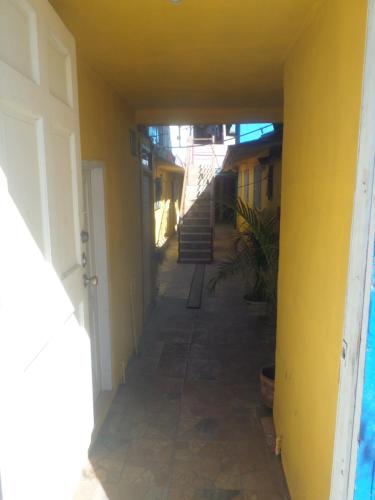 an empty hallway of a house with a yellow wall at Hospedaje Barato Mi Casita de Colores in Tijuana