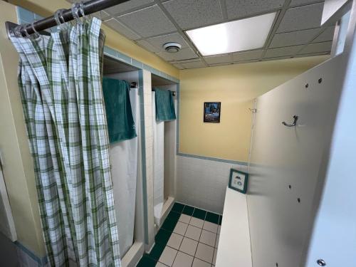 a shower in a bathroom with a shower curtain at CoHo: Conway Hostel in Conway