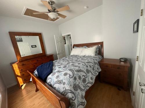 a bedroom with a bed and a ceiling fan at Cozy apartment in Shenandoah in Shenandoah
