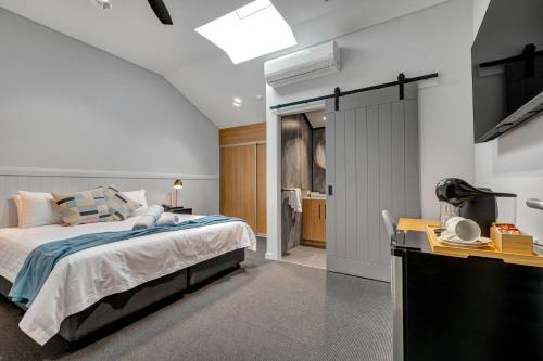 a bedroom with a bed and a television in it at Gawler Arms Hotel in Gawler
