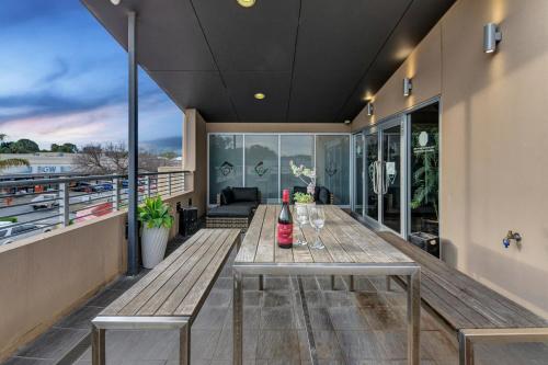 a balcony with a table with wine glasses on it at Gawler Arms Hotel in Gawler