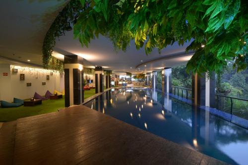 a hotel swimming pool with a view of a building at Grand Savero Hotel Bogor in Bogor