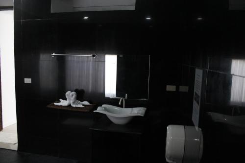 Baño negro con lavabo y aseo en SujungSesang Dive Resort, en Agus