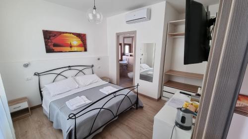 a small bedroom with a bed and a bathroom at B&B D'AMARE in Cupra Marittima