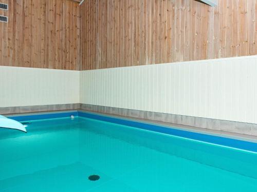 una piscina vuota con una parete in legno di 8 person holiday home in Oksb l a Oksbøl