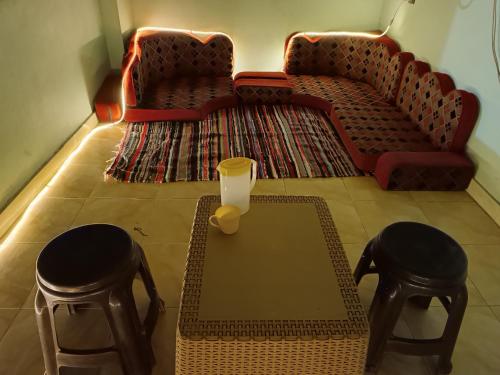 a living room with a coffee table and two stools at Private room in Dahab,10 minutes to sea in Dahab