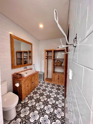 a bathroom with a sink and a toilet at The Seaglass Villas Bingin in Uluwatu