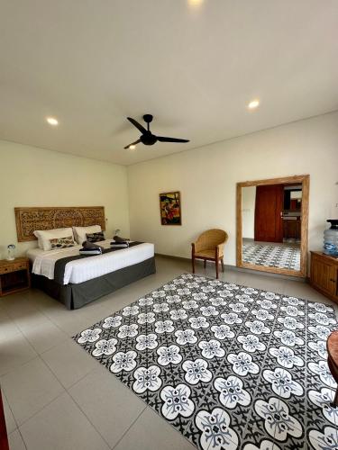 a bedroom with a bed and a large rug at The Seaglass Villas Bingin in Uluwatu