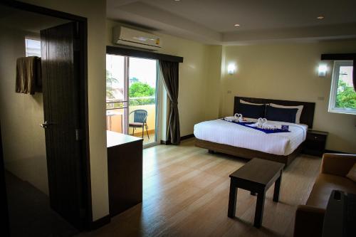 a hotel room with a bed and a balcony at Sky Villa Hua Hin Guesthouse - Adults-Only in Hua Hin