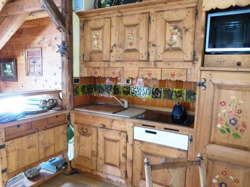 a kitchen with wooden cabinets and a sink in a cabin at Appartement Arêches-Beaufort, 3 pièces, 5 personnes - FR-1-342-297 in Beaufort