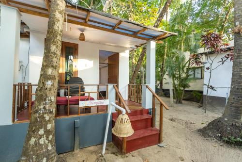 a house with a staircase leading to the front of it at Dreamcatcher By Brifton Hotel And Resorts in Palolem