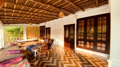a living room with a couch and a table at Dreamcatcher By Brifton Hotel And Resorts in Palolem