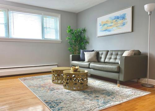 a living room with a couch and a rug at Simply Stays in Ottawa
