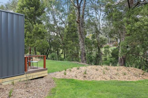 a house with a picnic table in a yard at Timboon Tiny Homes in Timboon