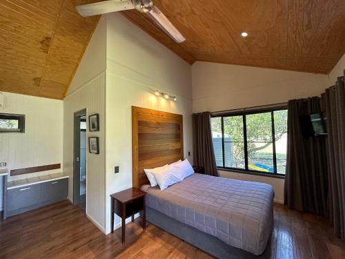 a bedroom with a bed and a large window at Hedlow Retreat in Barmoya