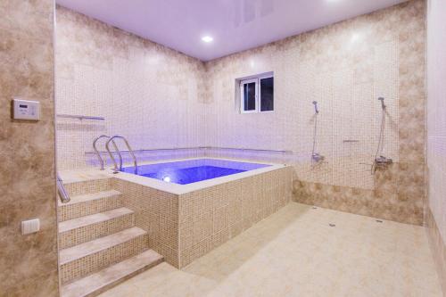 a large bathroom with a tub and a shower at Gabrielle International Hotel in Tashkent