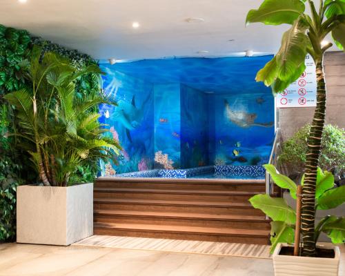 an aquarium with a large tank of fish at Queen Ann Nha Trang Hotel in Nha Trang