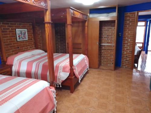a bedroom with two bunk beds in a brick room at COYOACAN DEPARTAMENTO TIPO COLONIAL in Mexico City