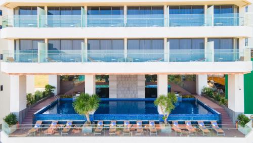 an aerial view of a building with a swimming pool at Queen Ann Nha Trang Hotel in Nha Trang