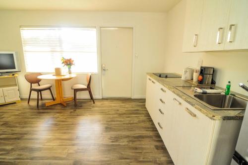 a kitchen with a sink and a table with chairs at Regency Inn & Suites Sarasota in Sarasota