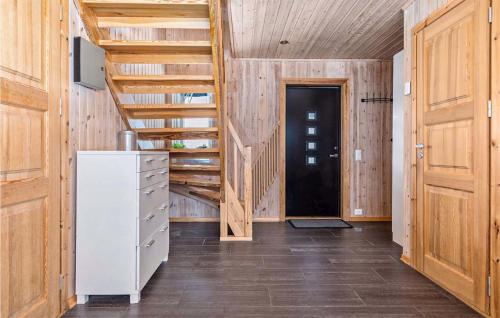 a hallway with wooden walls and a wooden staircase at Beautiful Home In Rauland With Sauna And 5 Bedrooms in Rauland