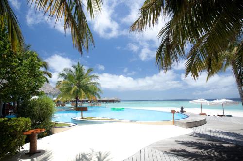a swimming pool with the ocean in the background at Filitheyo Island Resort in Filitheyo