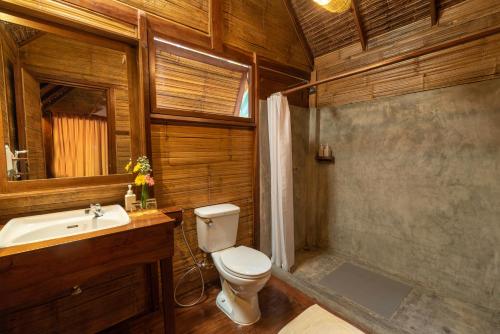une salle de bain avec toilettes et lavabo dans l'établissement Pai Village Boutique Resort, à Pai