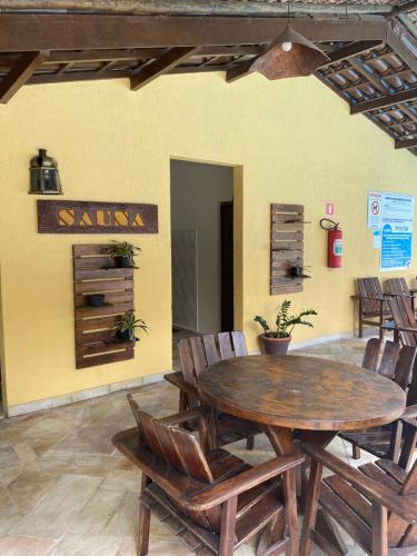 a dining room with a wooden table and chairs at Flat 102 in Riviera de São Lourenço