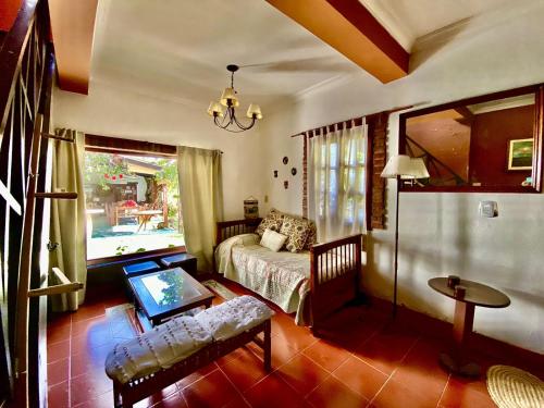 a living room with a bed and a table at Finca La Secundina in Salta