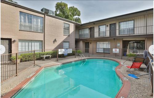 a swimming pool in front of a building at Cozy houston Getaway 1 bed 1 bath in Houston