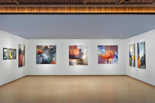 a gallery with many paintings on a wall at ARTOTEL Batam in Nagoya