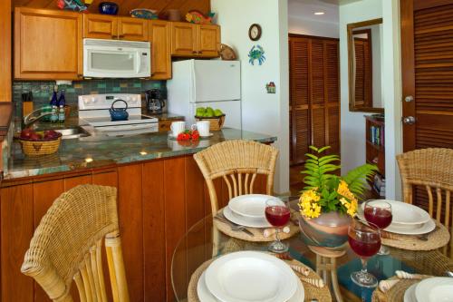 a kitchen with a table with chairs and a counter top at Gallows Point Resort in Saint John