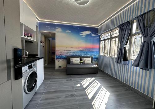 a laundry room with a painting of the ocean at 3BR Romantic apt, 2mins MTR, 8pax in Hong Kong