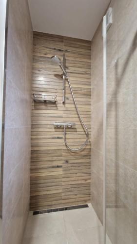 a bathroom with a shower with a glass door at Mytho 1 in Mýto pod Ďumbierom