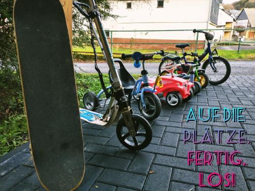 a group of bikes parked next to a skateboard at Familien-Apartment SchmitTs Katz 
