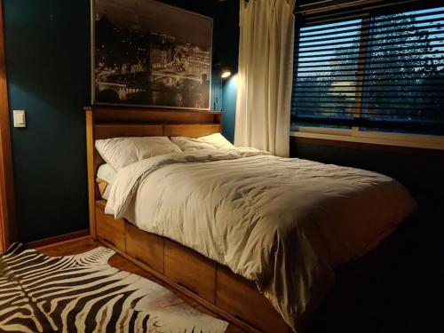 a bed in a bedroom with a zebra print rug at European garden house in Yeongju