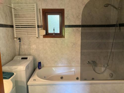 a bathroom with a tub and a toilet and a sink at Welcome, relax and enjoy your stay in Putten