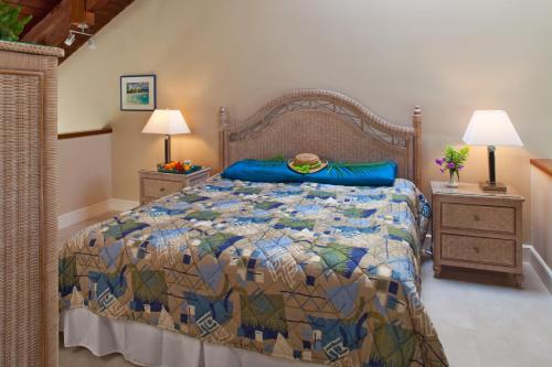 a bedroom with a bed with a colorful quilt at Gallows Point Resort in Saint John