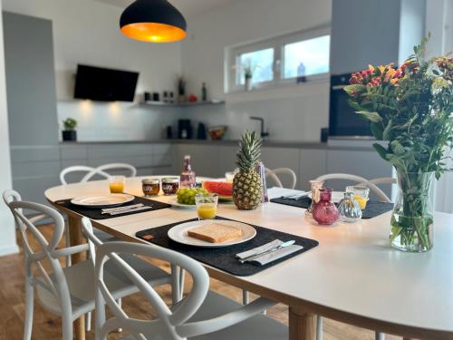 a dining room table with a plate of food on it at NEU! Feriendomizil TraumZeit 1 mit Sauna & Garten in Göhren-Lebbin