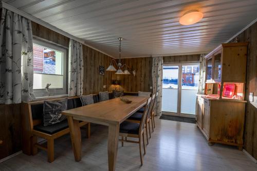 a dining room with a wooden table and chairs at Chalet Alpenglück by Kaprun Rentals in Kaprun