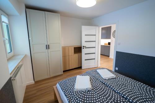 a bedroom with a bed with a blue and white bedspread at Filip 358 in Szklarska Poręba