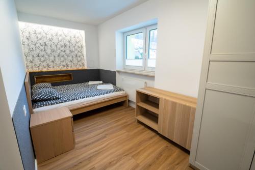 a small bedroom with a bed and a window at Filip 358 in Szklarska Poręba