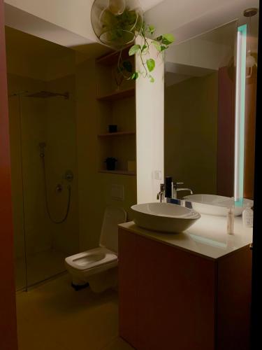 a bathroom with a sink and a toilet and a shower at Downtown Italian Studio in Bucharest