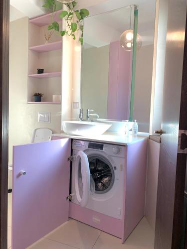 a bathroom with a washing machine and a sink at Downtown Italian Studio in Bucharest