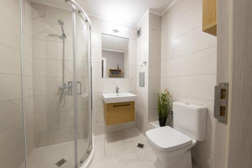 a bathroom with a shower and a toilet and a sink at Emilia Romana Park in Sunny Beach