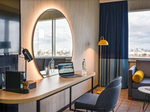 a hotel room with a desk with a laptop on it at Mercure Antwerp City South in Antwerp