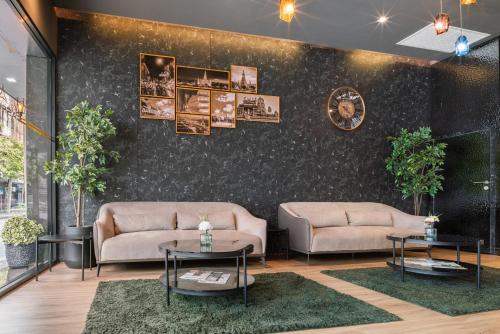 a living room with two couches and two tables at Aspira Gems Center Silom in Bangkok